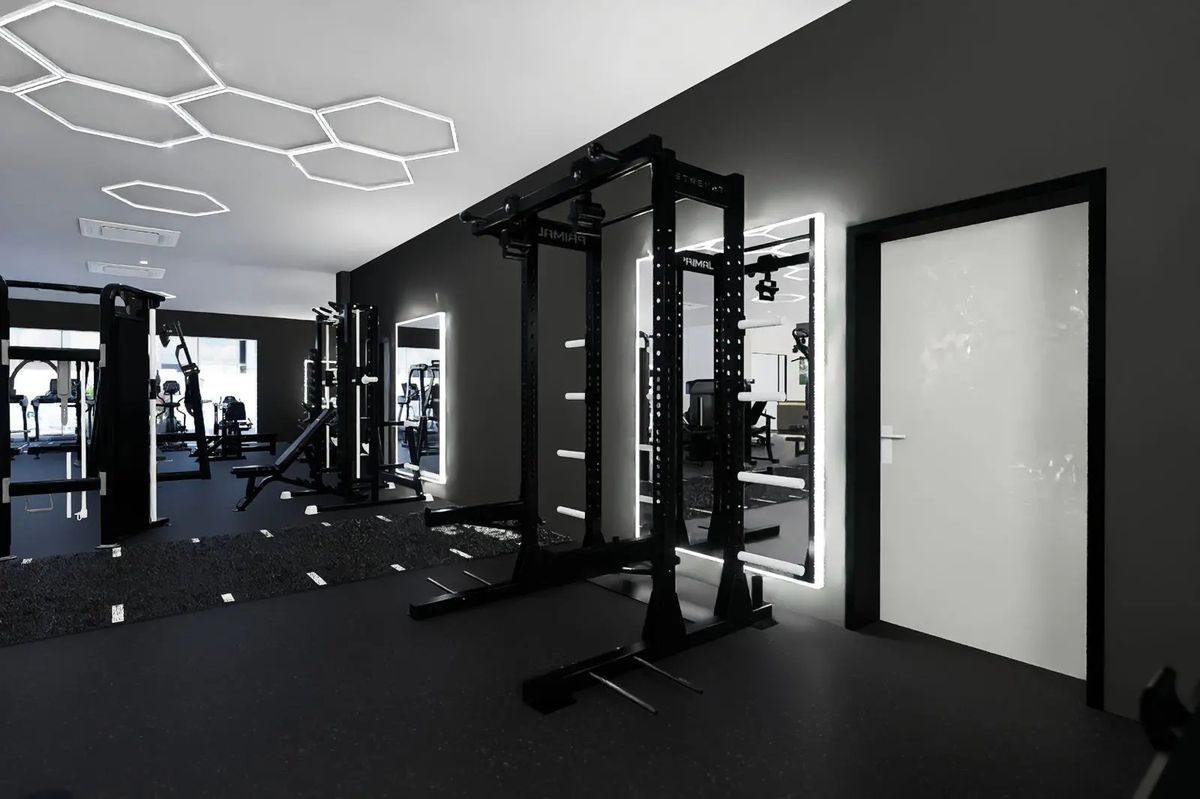 A Primal rack beside lit mirrors under the hexagon lights